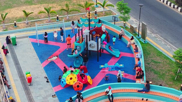 Aerial view of Teras Samarinda 2 playground with colorful climbing structures and children playing in Samarinda, East Kalimantan, Indonesia.