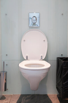 Wall-mounted toilet installation at home bathroom