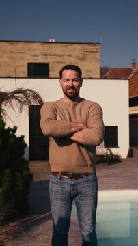 Man enjoying warm spring sunlight on face while standing outside.