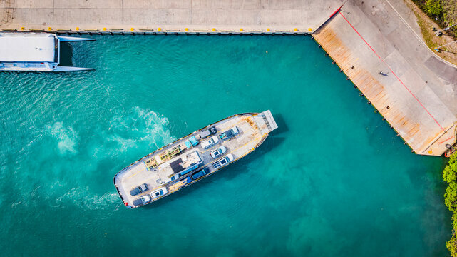 Top down aerial view of a car ferry arriving at Cruz Bay port.