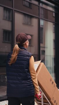 Female courier delivering a package.