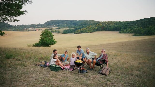 Family relaxing and spending time together at campsite.