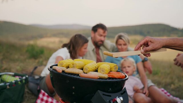 Family relaxing and spending time together at campsite.