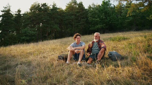 Family relaxing and spending time together at campsite.