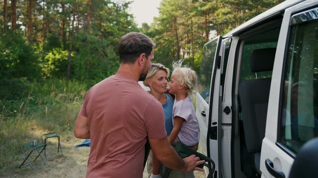 Family relaxing and spending time together at campsite.