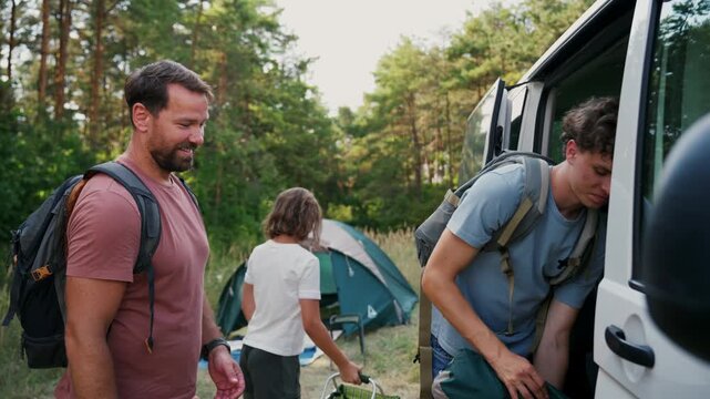 Family relaxing and spending time together at campsite.