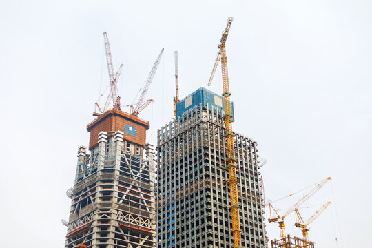 Construction. Cranes building modern skyscraper