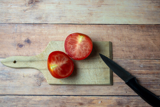 Fresh Tomato Halves on Wooden Cutting Board