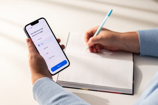 Psychologist giving smartphone with psychology test to patient to answer questions. Digital tools to help, support and understanding client needs during session