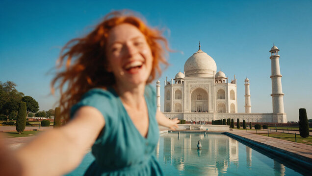 Cheerful Young Woman Taking Selfie at Taj Mahal India