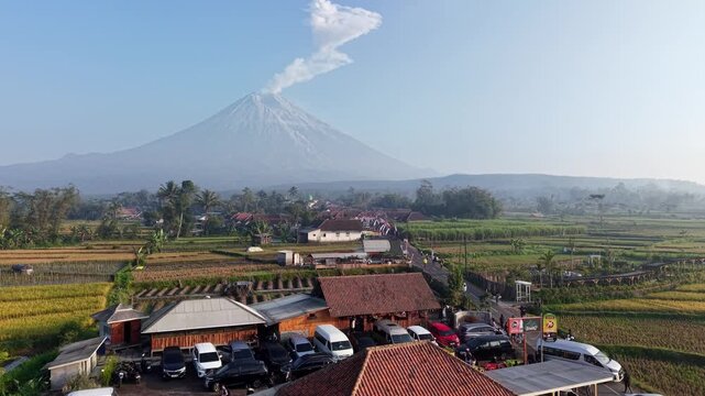 Aerial view captures Mount Semeru plume rising over fields at Teras Semeru