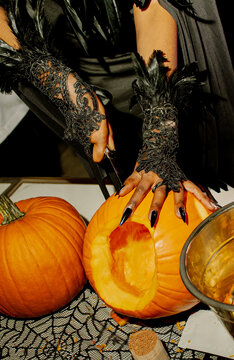 witch hands with black nails and halloween pumpkin and pumpkins, 31st October holiday