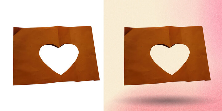 Brown crumpled paper sheet with heart shaped cutout for romantic greeting cards.