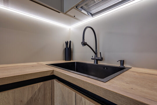  details of corner with water tap sink with faucet with soap and shampoo dispensers in expensive bathroom in rustic eco style