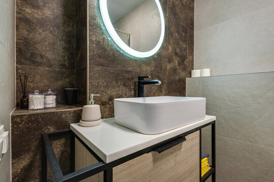  details of corner with water tap sink with faucet with soap and shampoo dispensers in expensive bathroom in rustic eco style
