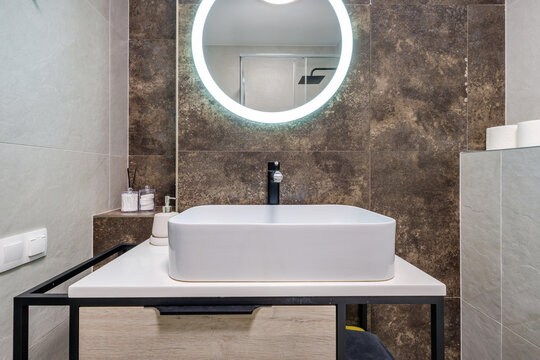  details of corner with water tap sink with faucet with soap and shampoo dispensers in expensive bathroom in rustic eco style