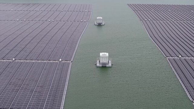 Floating solar panels stretch across calm green waters at Waduk Karangkates