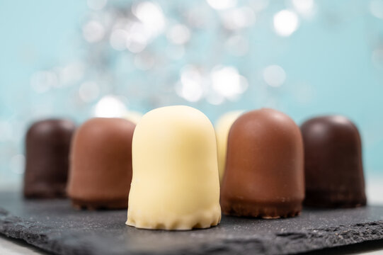 Chocolate teacakes, coated marshmallow treats, krembo, pastry sweets with cookies, fluffy cream and glaze, traditional winter dessert, food selection