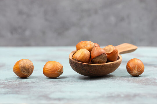 Hazelnuts in a wooden shovel, healthy nuts food, nutrition, ingredients for baking, protein and antioxidants