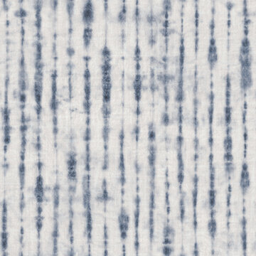 Indigo blue watercolor shibori tie dye stripes seamless pattern on linen texture