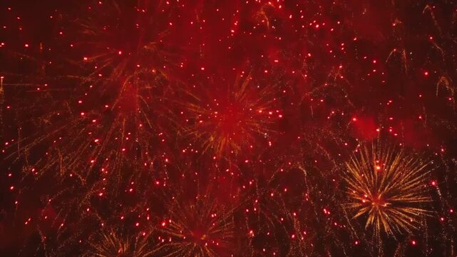 Bright red fireworks exploding in night sky, festive celebration display, glowing pyrotechnics sparks, traditional holiday party background, happy new year festival event, beautiful golden light burst