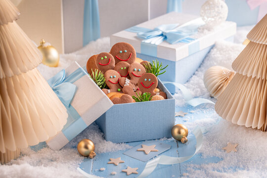 Endearing gingerbread men arranged inside light blue packages.