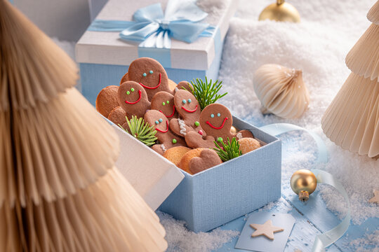 Lovely gingerbread people resting in soft blue containers.