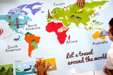 Children's hands on a colorful world map poster with continents labeled. © Rawpixel.com