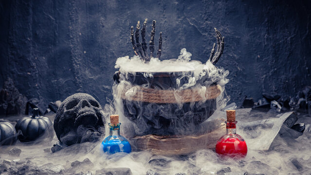 Wide shot of smoking witch cauldron with potions skull pumpkin
