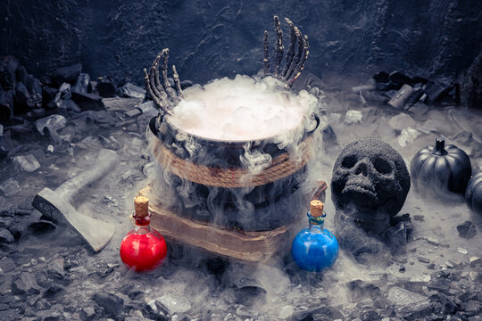 Witch cauldron steaming in fog with red and blue potions