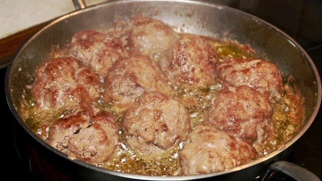 frying raw homemade minced meatballs in hot oil