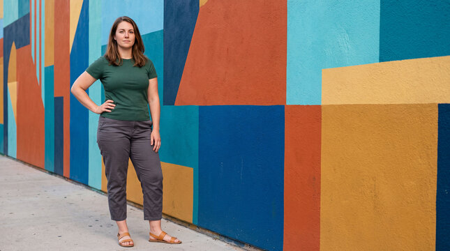Proud woman standing in a colorful modern setting