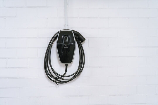 Charging station for electric cars, home charging station for electric vehicles in the garage. Wall-mounted charger or charge point for electric vehicles