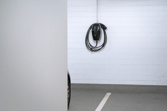 Charging station for electric cars, home charging station for electric vehicles in the garage. Wall-mounted charger or charge point for electric vehicles