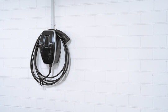 Charging station for electric cars, home charging station for electric vehicles in the garage. Wall-mounted charger or charge point for electric vehicles