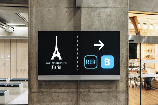 Roissy-en-France, France - October 6, 2026: Illuminated directional sign with an Eiffel Tower symbol guiding passengers to the RER B train service to Paris at Charles de Gaulle Airport.