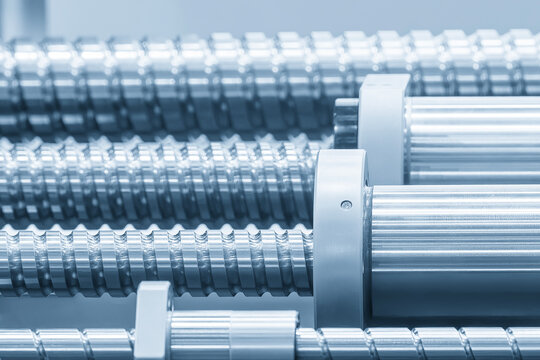 Close-up of a ball screw and bushing set in a CNC milling machine structure in a blue tone scene