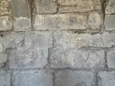 Close-up texture of ancient Roman stone wall masonry and ashlar blocks at Aspendos theatre in Serik, Antalya, Turkey, displaying historic architectural craftsmanship.