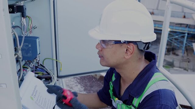 Environmental engineer communicating with team of technicians use radio and taking reports checking continuous emission monitoring systems at industrial plant. Sustainable air pollution reduction. ESG