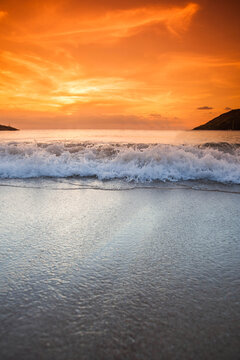 Beautiful sunset over the tropical beach with purple sky