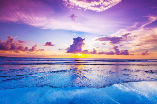 Beautiful sunset over the tropical beach with purple sky