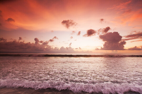 Beautiful sunset over the tropical beach with purple sky