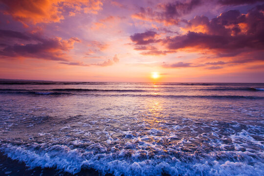 Beautiful sunset over the tropical beach with purple sky