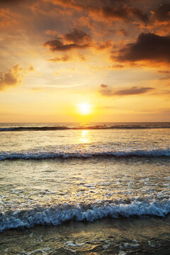 Beautiful sunset over the tropical beach with purple sky