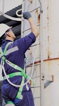 Engineers wearing harness safety climbing up the chimney to check and measure carbon dioxide levels or for air pollution reduction, continues emission monitoring system. Sustainable Environment. ESG