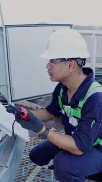 Environmental engineer communicating with team of technicians use radio and taking reports checking continuous emission monitoring systems at industrial plant. Sustainable air pollution reduction. ESG