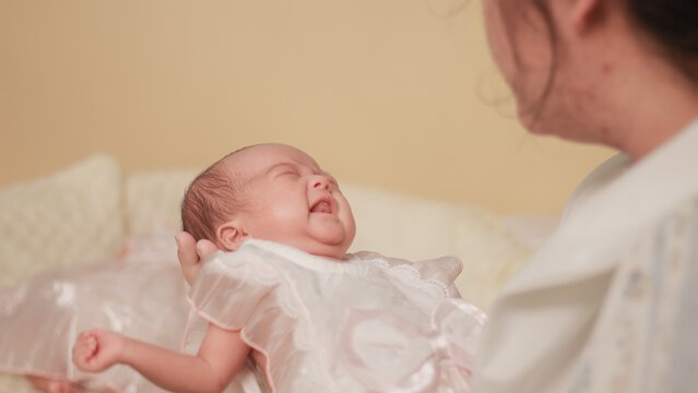 Maternal love, bonding, intimacy and family tenderness. Close up of a mother gazing affectionately at her newborn baby, highlighting their face to face connection in soft natural light.