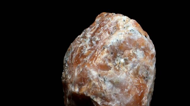 Orchid Calcite - mixture of Orange Calcite and Tourmaline - rotating against a black background