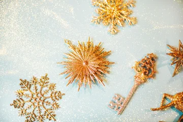 Golden beautiful sparkling christmas decoration on pastel blue background. Place for text. Festive concept. © Anna Efetova