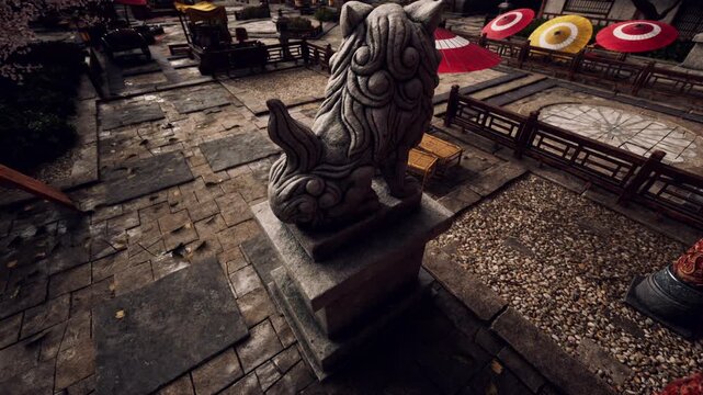 Detailed stone guardian lion statue stands proudly on a stone pedestal inside a traditional Asian courtyard with red and yellow umbrellas and stone pathways during daytime